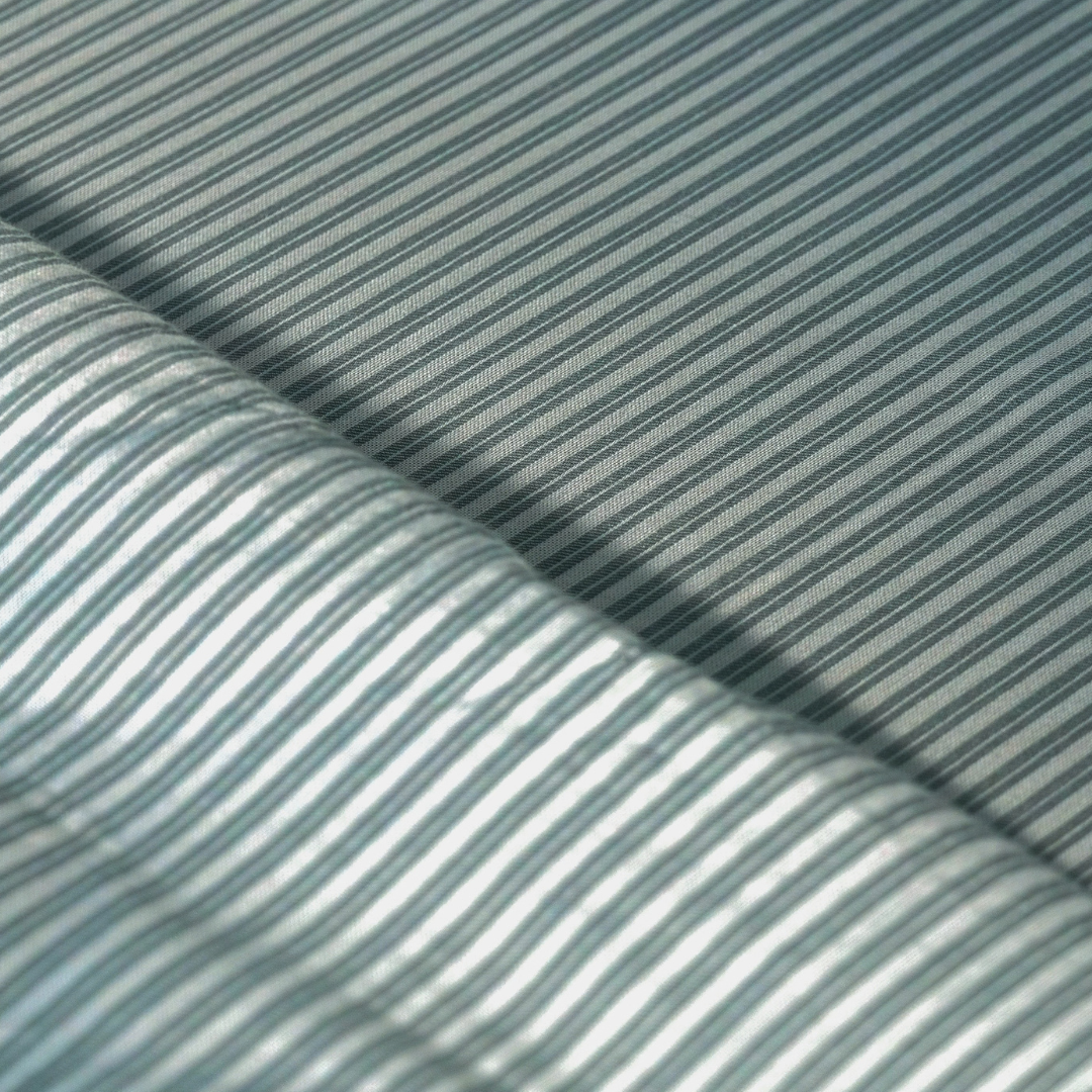 Close-up of the yarn dyed pine green and white pin stripe percale weave